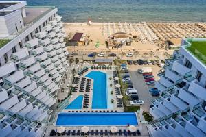 an aerial view of a hotel and a beach at Infinity by Sea Apartment Beach Resort - parking in Mamaia