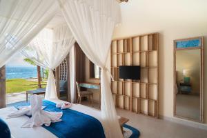珀尼達島的住宿－The Sankara Beach Resort - Nusa Penida，一间卧室设有一张床,享有海景