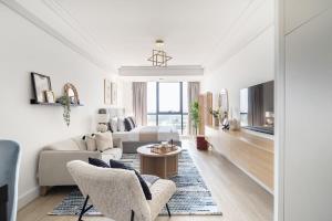 a living room with a couch and a table at Frank Porter - Goldcrest Views 2 in Dubai