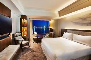 a hotel room with a large bed and a window at InterContinental Tokyo Bay by IHG in Tokyo