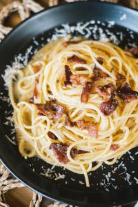 a bowl of pasta with bacon and cheese at Panorama Villas El Nido in El Nido