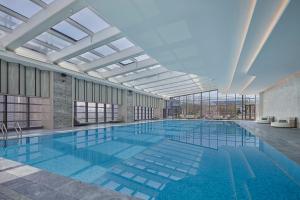 a large swimming pool in a building at Yancheng Marriott Hotel in Yancheng
