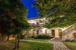 an exterior view of a house with trees at Cinarli Kasri in Gokceada Town