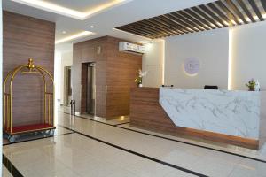 a lobby with a reception desk in a building at De Iris Regency Fahaheel in Kuwait