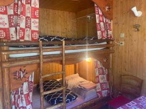 a room with two bunk beds in a cabin at Le p'tit coin montagne in Bonneval-sur-Arc