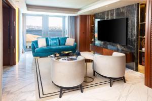 a living room with a couch and a tv at The Maestro Hotel in Istanbul