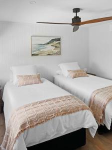 two beds sitting next to each other in a bedroom at Pod on the Park in Kiama