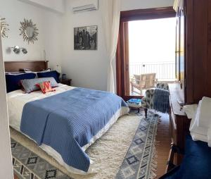 a bedroom with a bed and a large window at Bellavista at Heraion Lagoon in Loutraki