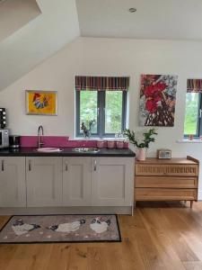 a kitchen with a sink and a counter top at The Hen House A beautifully situated open plan chalet in Lothersdale