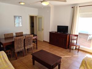 a living room with a dining room table and a television at REf 112 ATICO EN ZAHARA MAR in Zahara de los Atunes