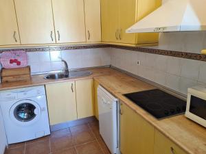 a kitchen with a sink and a washing machine at REf 112 ATICO EN ZAHARA MAR in Zahara de los Atunes