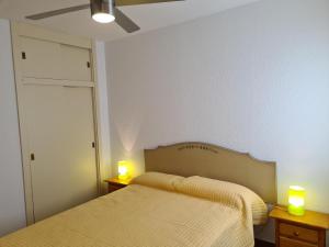 a bedroom with two beds and two candles on tables at REf 112 ATICO EN ZAHARA MAR in Zahara de los Atunes +10 photos