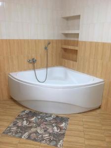 a white bath tub in a bathroom with a rug at Chalupa Vojtěchov in Hvozd