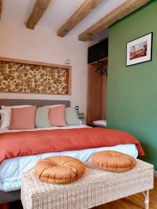 a bedroom with a bed with two pillows on it at Le Terrier in Miserey-Salines