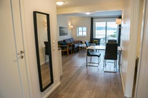 a dining room and living room with a table and chairs at Florø Rorbu in Florø