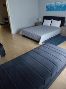 a large bed in a room with a blue mattress at Apartments Tatjana in Jagodina