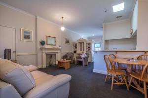 a living room with a couch and a table at Foreshore Apartment 104 in Albany