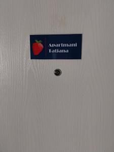 a sign on a refrigerator with a strawberry on it at Apartments Tatjana in Jagodina