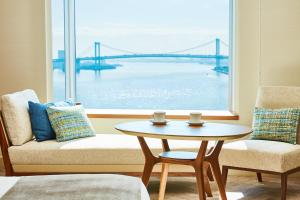 a living room with a table and a view of a bridge at InterContinental Tokyo Bay by IHG in Tokyo