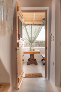 a dining room with a table and a window at Mythical Luxury Apartment in Naxos Chora