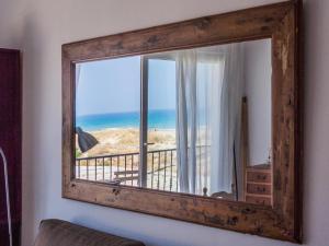 a mirror in a room with a view of the beach at REf 38 CASA GUSTAVO in Zahara de los Atunes
