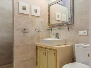 a bathroom with a sink and a mirror and a toilet at REf 38 CASA GUSTAVO in Zahara de los Atunes