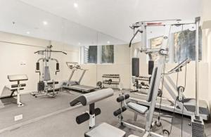 a gym with several exercise equipment in a room at Beautiful 2-Bed Apartment with ocean views of Barangaroo in Sydney