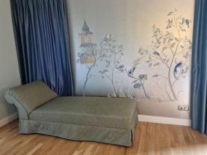 a living room with a chair and a painting on the wall at Zalves House in Riga