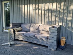 a couch sitting on a porch with a table at Zalves House in Riga