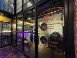 a window of a store with a sign in it at INNO Hostel & Pub Lounge Hongdae in Seoul