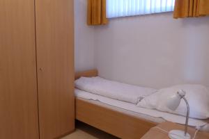 a small bedroom with a bed and a window at Tief 12 Hafenkieker mit Internet 53 in Wangerland