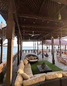 a living room with a couch on a pier with the ocean at Villa Florita Beach House in El Remate