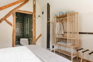 Les Callots - Maison d'hôtes في Champignelles: غرفة نوم بسرير وخزانة