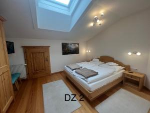 a bedroom with a bed and a skylight at Penthouse Appartement in Kirchberg in Tirol