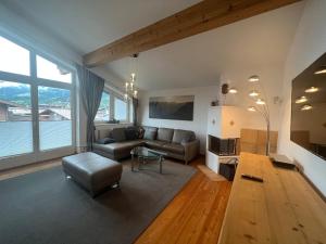 a living room with a couch and a table at Penthouse Appartement in Kirchberg in Tirol