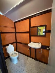a bathroom with a toilet and a sink at Numpu Baandin in Sam Roi Yot