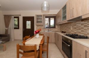 a kitchen with a table and a dining room at Melissa Luxury Apartments in Agios Leon +46 photos