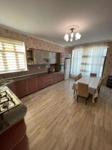 a large kitchen with a table and a dining room at Villa in Gabala in Gabala