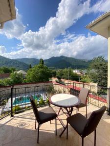 a patio with a table and chairs on a balcony at Villa in Gabala in Gabala