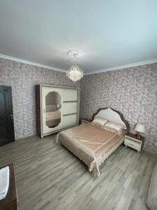 a bedroom with a bed and a chandelier at Villa in Gabala in Gabala