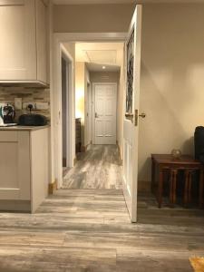 a hallway leading into a kitchen with a door open at Harmony House enclosed property near beach and lake in Tramore