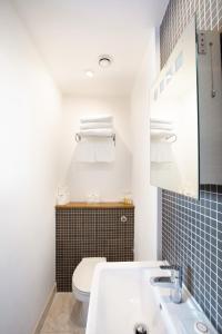 a bathroom with a white sink and a toilet at The Cleveland in London +35 photos