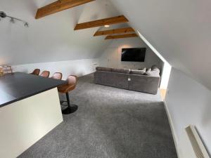 a living room with a couch and a television at Pilgrim Hotel in Hereford