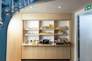 a display cabinet with various items on it in a room at Hôtel Suzane in Angers