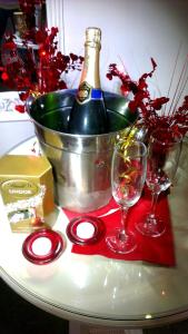 a bottle of wine sitting on a table with two glasses at The Bath House Boutique B&B - IN-ROOM Breakfast - FREE parking in Bath