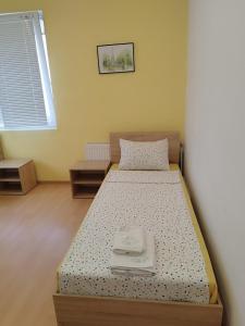 a bedroom with a bed with a tray on it at Family Hotel Kentavar 2 in Byala