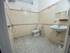 a bathroom with a toilet and a sink at VALENTINE Hotel in Da Lat