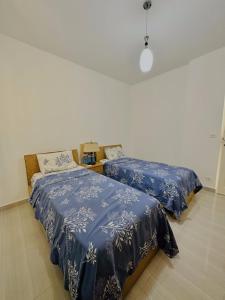 A bed or beds in a room at Luxor Rose Villa