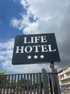 a sign for a life hotel in front of a building at Life Hotel in Casalnuovo di Napoli