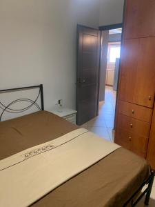 a bedroom with a bed and a dresser and a door at chris house in Kalamata